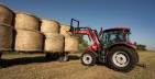 McCormick tractor off loading bales
